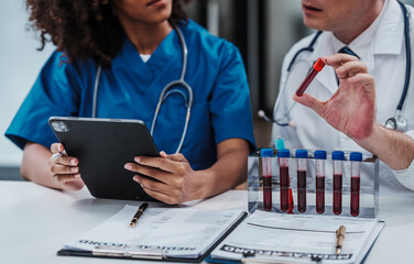 Team meeting lab assistant african american people holding test tube with blood sample research and...