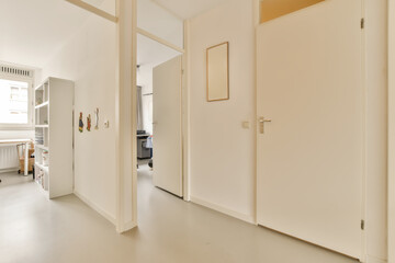 an empty room with white walls and door handles on the doors are closed to let in light into the room