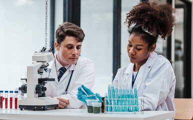 Chemologist explains examining blood in test tube. Examples of drugs for treatment of hematological diseases, blood diseases refer to diseases, disorders of the hematopoietic system, immune system