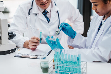 Chemologist explains examining blood in test tube. Examples of drugs for treatment of hematological diseases, blood diseases refer to diseases, disorders of the hematopoietic system, immune system