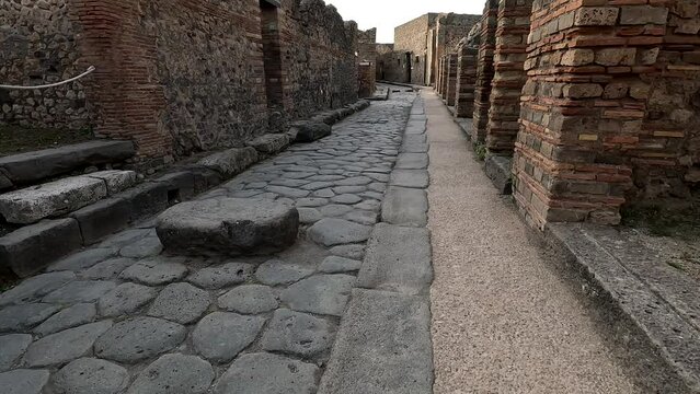 Famous ancient city of Pompeii (Scavi di Pompei) near Naples. Roman period historical ruins and stone footpath walkways of the ancient city. Italy