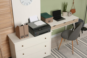 Stylish workplace with laptop and modern printer indoors