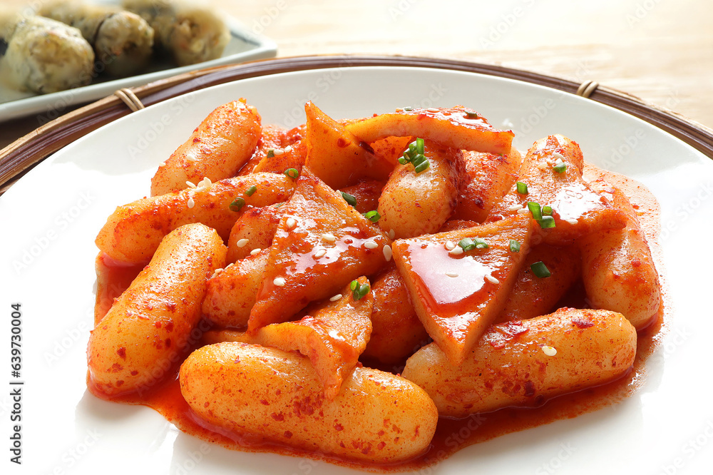 Wall mural Korean food, Rice cake stick in a spicy gochujang sauce and fish cakes. Tteokbokki and Fried seaweed rolls or Gimmari on white background. Korean Stir-fried Rice Cake