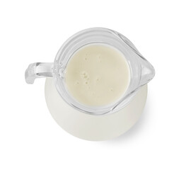 Glass jug of fresh milk isolated on white, top view