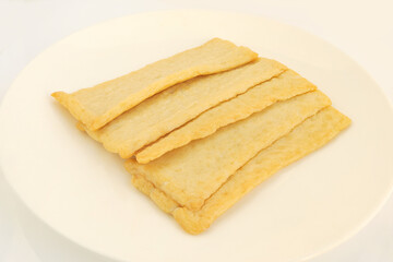 Fototapeta na wymiar Korean Thin Fish cake, square shaped on white background. Asian food fish cake, eomuk or odeng.