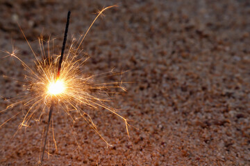 Close up of Sparkler on beach. Burning sticks of Bengal fire, Sparks of bright bengal lights burning on the beach.