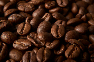 Aromatic Elegance: A close-up masterpiece capturing the intricate details of coffee beans on a rich wooden texture. The interplay of texture and aroma unfolds against a warm backdrop