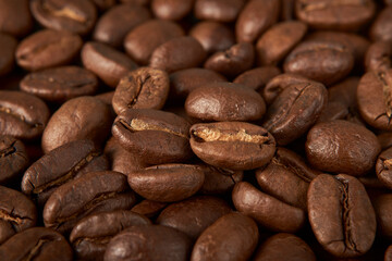 Aromatic Elegance: A close-up masterpiece capturing the intricate details of coffee beans on a rich wooden texture. The interplay of texture and aroma unfolds against a warm backdrop