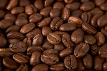 Fototapeta premium Aromatic Elegance: A close-up masterpiece capturing the intricate details of coffee beans on a rich wooden texture. The interplay of texture and aroma unfolds against a warm backdrop