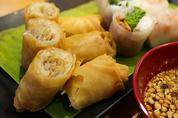 Vietnamese cuisine, Fried spring rolls, deep fried spring rolls with sweet chili sauce served in a dish. Top view.
