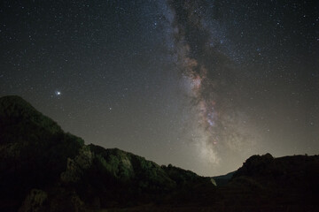 Night landscape in the Pyrenees mountains with Milky Way and planet Jupiter above, Janovas, Aragon, Huesca, Spain