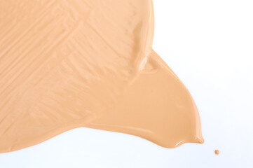 Abstract smear of Liquid foundation sample on a white background. Background made of liquid foundation. makeup concept