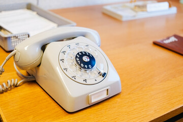 Old wheel and cord telephone, white, vintage