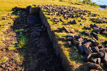 Fototapeta na wymiar Peat blocks, in a traditional peat bog, on the coast of Ireland