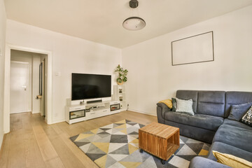 a living room with couches and a flat screen tv on the wall in front of the sofa is an entertainment center