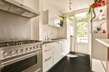 a kitchen with an oven, sink and dishwasher in the photo is taken from the inside looking into the room