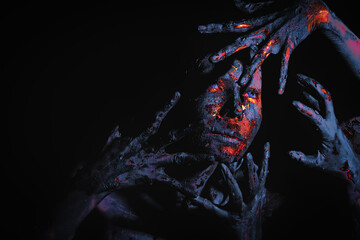 abstract bodypaint for Halloween concept of fancy makeup of scary bloody witch on dark background