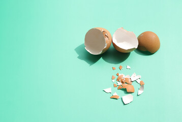 Group of broken egg shells on green background. Recycling kitchen waste, Crushed egg shells for the...