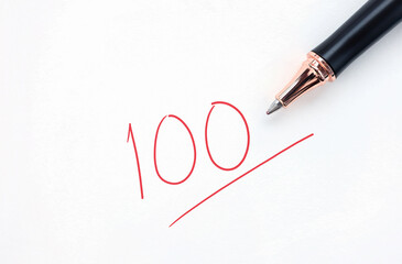 Educational concept, pen with written in red ink on white paper. full score test,red 100 full mark...