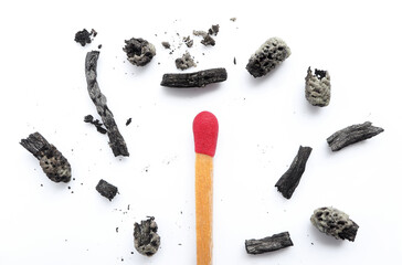 New matchstick, a whole red match and burned matchsticks on a white background. flat lay, burnt match to the dust. 