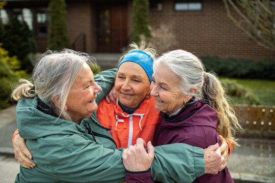 Female seniors walking and exercising together in the suburbs