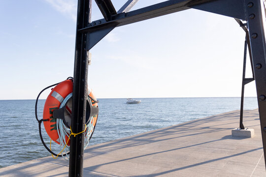 Life raft on catwalk on pier with boat in background at Grand Haven State Park in Grand Haven, Michigan, western Michigan, Lake Michigan, Great Lakes