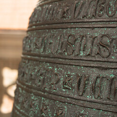 Close up of a carved church bell