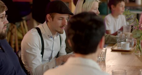 Person in club to improve public speaking, presentation. Active gesticulation, showing palms to opponent. Debate Clubs background. Man practice presenting arguments, open to feedback. People in cafe.