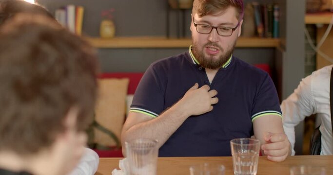 Portrait of talking man indoors. English language classes workshops that focus on communication skills and role-playing scenarios. Idiolect is person's specific, unique way of speaking. Hands gestures