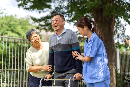 Portrait of smiling caring asian nurse service help support discussing and consulting taking care with senior elderly asian man and woman couple at home visit.senior retirement home care concept
