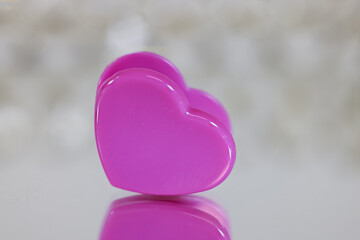 Pink Heart shaped clip close up view with reflection shallow depth of field.