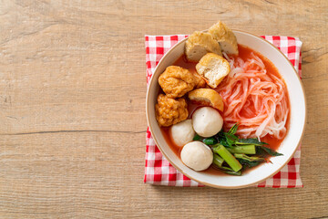 small flat rice noodles with fish balls and shrimp balls in pink soup, Yen Ta Four or Yen Ta Fo