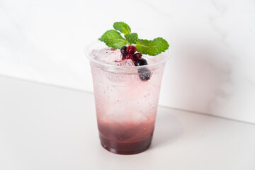 mix berry with soda in glass