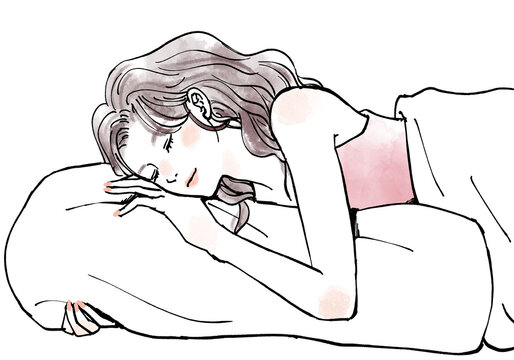 枕を抱いて眠る女性