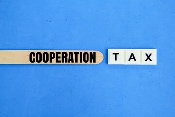 ice cream sticks and letters of the alphabet with the word Cooperation tax. tax concept for the corporate group