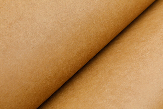 close up of rolled up brown Washable kraft paper on white background with copy space