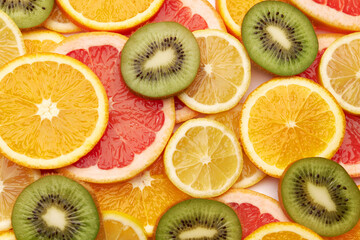 Fototapeta na wymiar top down background view made of Fresh Sliced organic kiwi, oranges and lemons close-up