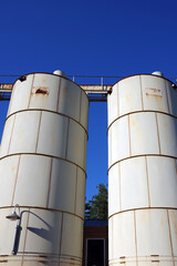 Old Decommissioned Silos under Blue Sky