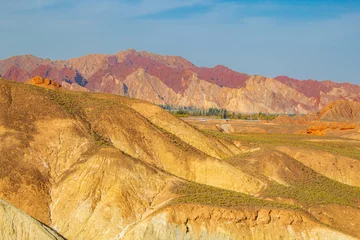 Photo sur Plexiglas Zhangye Danxia The beautiful colorful rock in Zhangye Danxia geopark of China during the sunset with blue sky and copy space for text