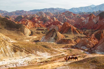 Photo sur Plexiglas Zhangye Danxia Aerial view on People on camels in the colorful rainbow mountains of Zhangye danxia landform geological park in Gansu province, China, horizontal