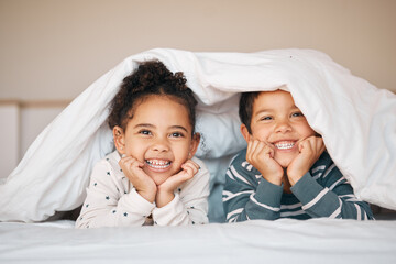 Siblings, happy and portrait of children in bed in blanket for bonding, love and fun at home....
