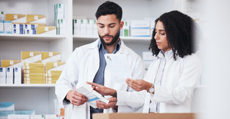 Healthcare, medicine and a pharmacy team with a box of prescription or chronic medication in a drugstore. Medical, pharmaceutical product and a pharmacist in a clinic with a colleague for health
