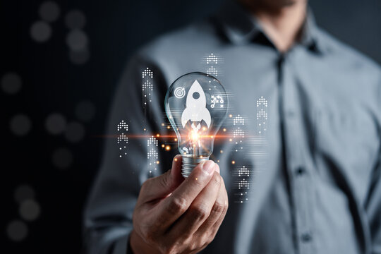 Rocket launch idea inside lightbulb with arrows up. strategically planning and initiating a corporate startup. aim to achieve objectives through value development, fostering leadership.
