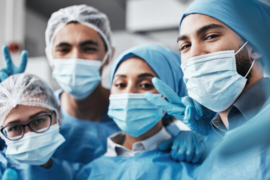 Healthcare, teamwork and surgery, selfie in operating room in medical emergency at hospital. Face of doctor, nurses and surgical team taking picture in operation with ppe, face mask and scrubs.