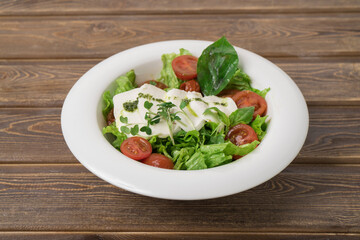 Green vegan salad from green leaves mix and vegetables.