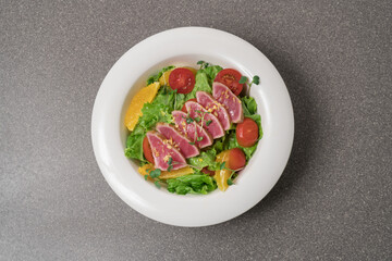 Salad with pieces of tuna on a plate