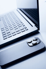 Laptop with smartphone. Close up image.