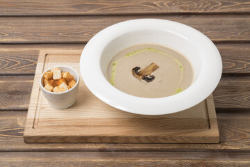 Mushroom cream soup on wooden background