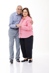 Full length of senior couple dancing on white background