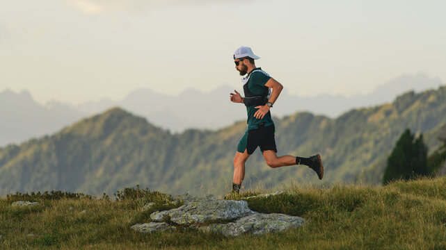 Young man runs in the mountains
